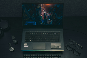 Gaming laptop on black desk.